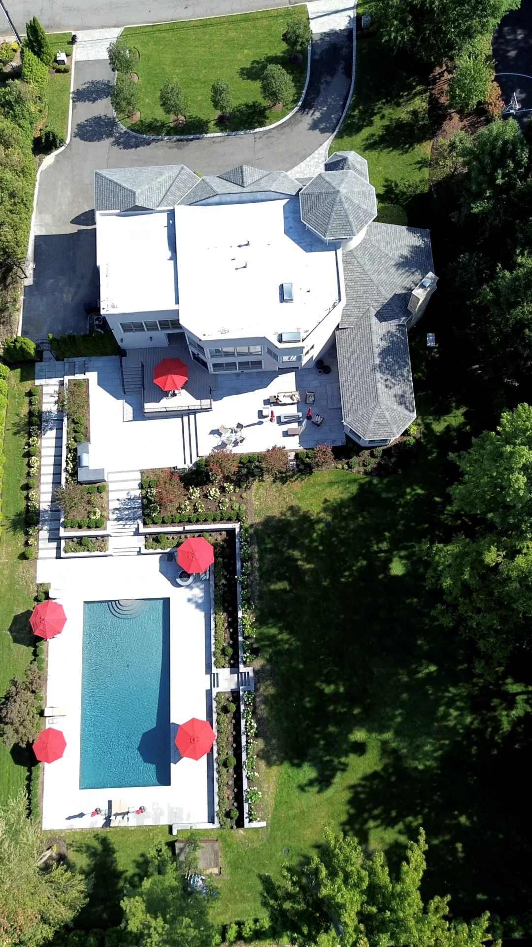 A bird 's eye view of a large white house with pool and patio.