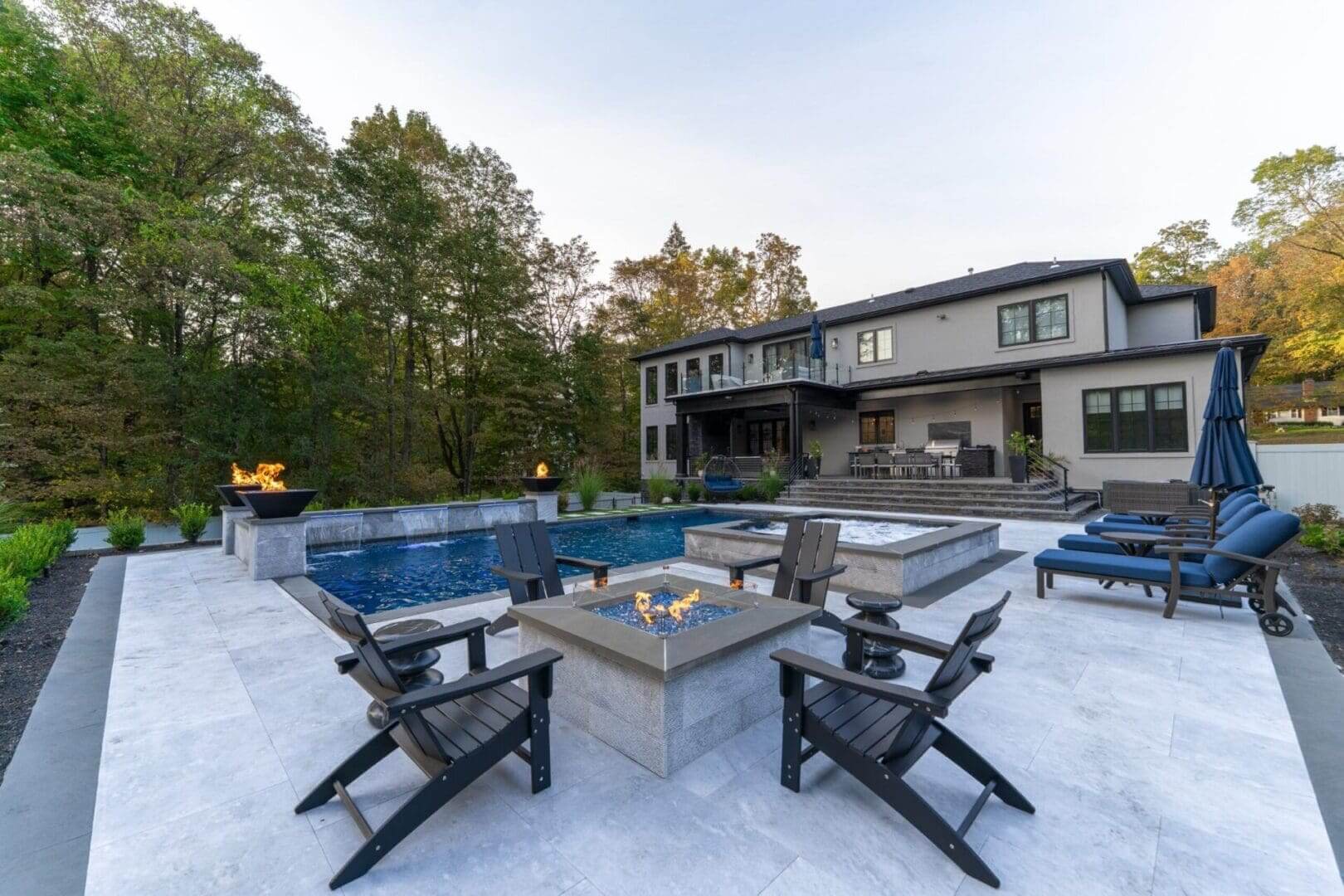 Modern backyard patio with pool and firepit