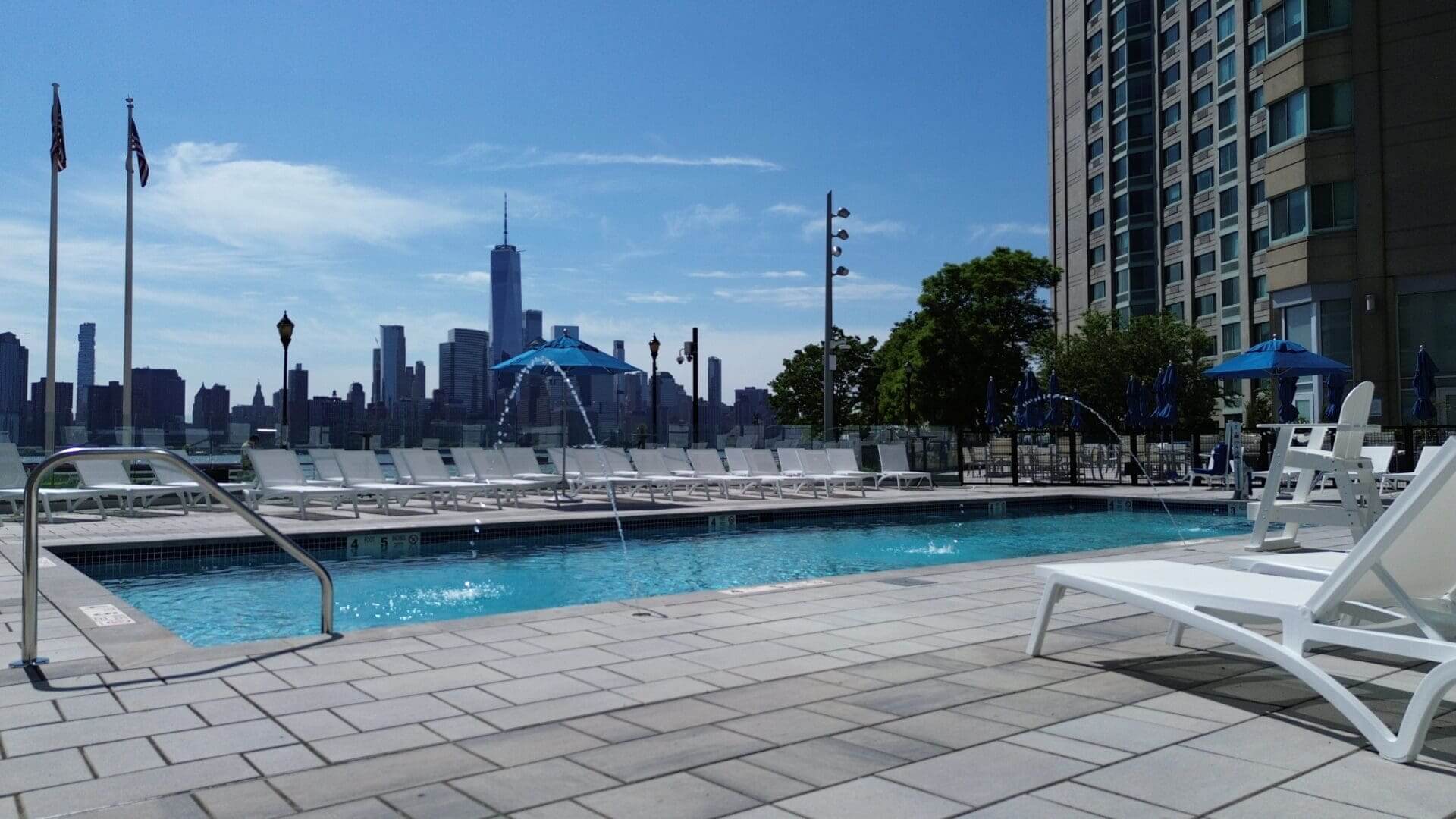 Riverside pool with city skyline view